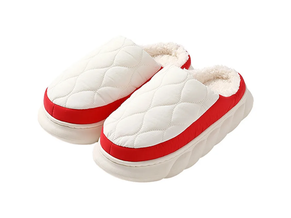 A pair of white and red quilted slippers with a thick, textured sole.