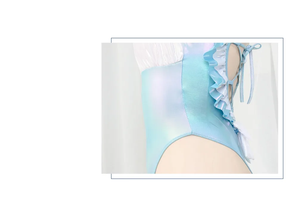 Close-up of the side of the iridescent blue swimsuit showing the ruffle trim and lace-up detail.