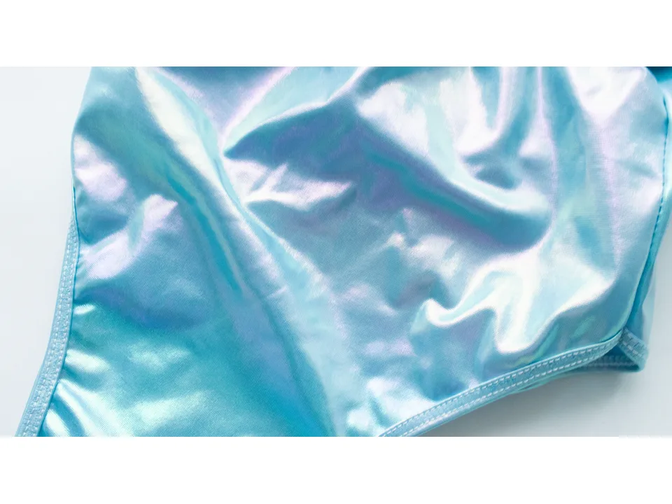 Close-up of the iridescent blue fabric of the swimsuit.