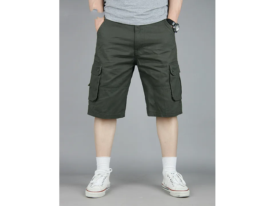 A man wearing dark green cargo shorts with side pockets.