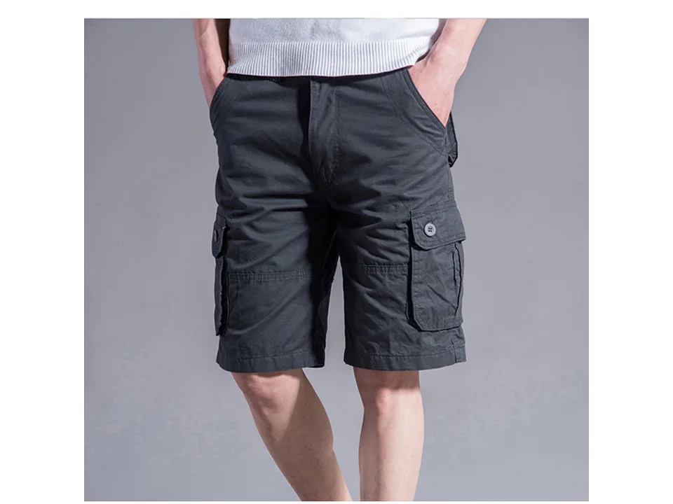 A man wearing dark grey cargo shorts with side pockets.