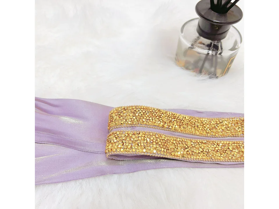 A close-up view of the gold embellished belt accessory.