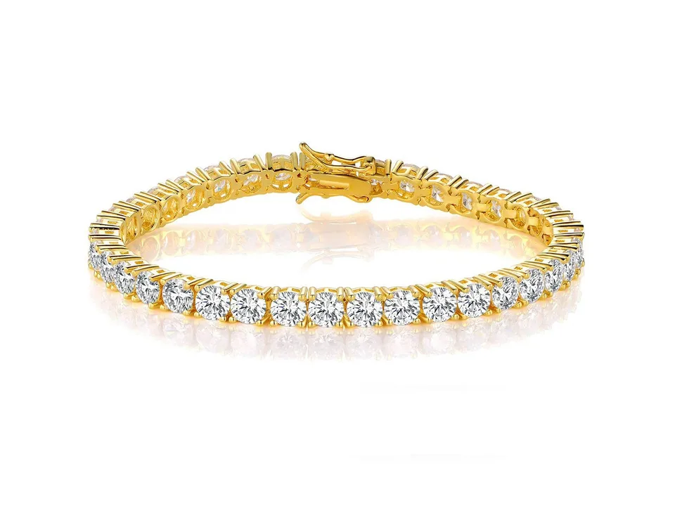 Gold tennis bracelet with clear cubic zirconia stones on a white background.