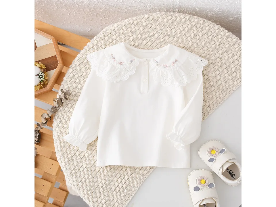 Full view of the white long-sleeve shirt with an embroidered lace collar.