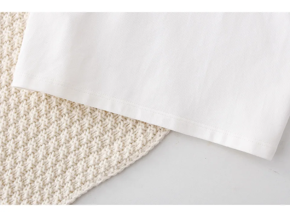 Close-up of the white shirt hem and fabric texture.