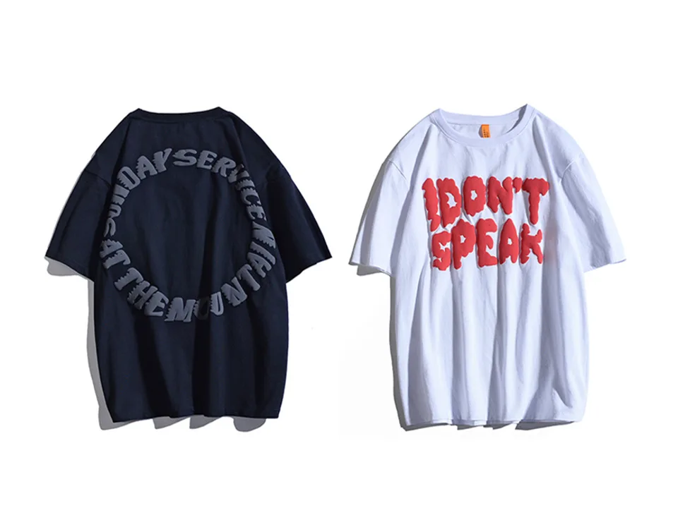 White oversized t-shirt with red 3D 'I DON'T SPEAK' lettering next to a dark navy shirt.