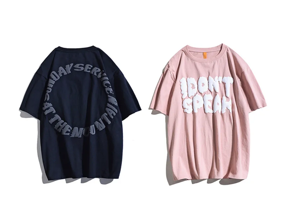 Pink oversized t-shirt with white 3D 'I DON'T SPEAK' lettering next to a dark navy shirt.