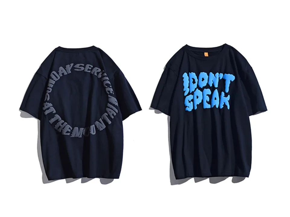 Dark navy oversized t-shirt with blue 3D 'I DON'T SPEAK' lettering next to a dark navy shirt.