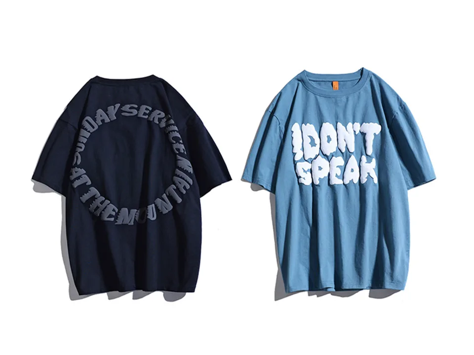 Blue oversized t-shirt with white 3D 'I DON'T SPEAK' lettering next to a dark navy shirt.