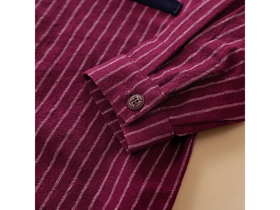 Close-up of the maroon striped baby romper sleeve cuff with a button.
