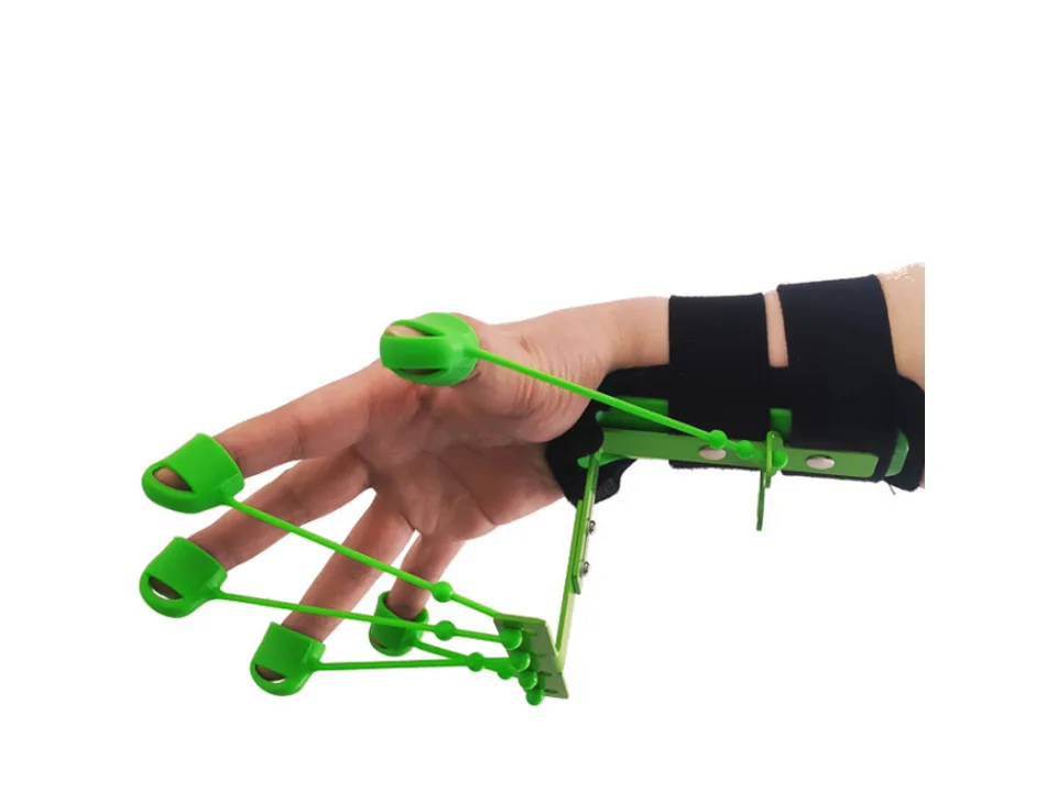 A hand wearing a green finger and wrist extensor trainer.