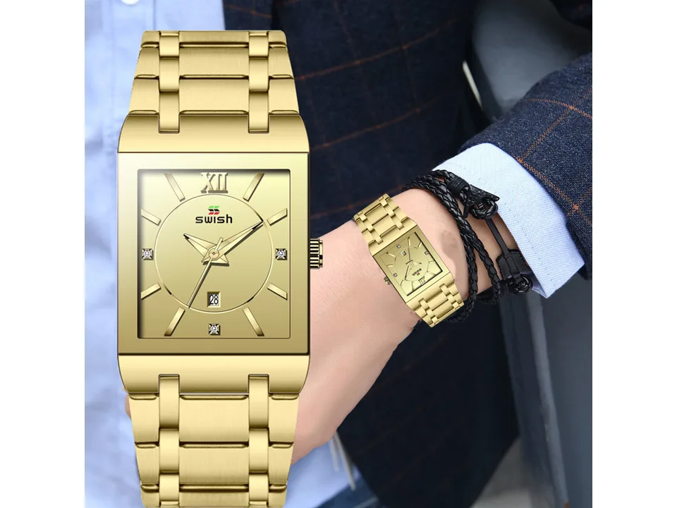 Gold analog watch worn on a person's wrist.