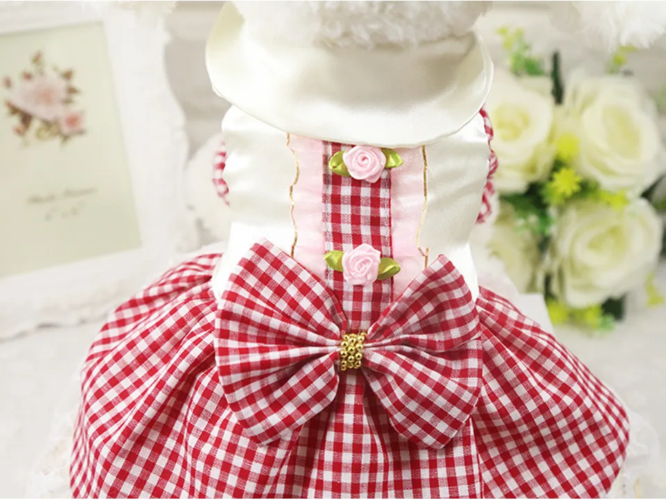 Close-up of the red plaid skirt showing the bow and decorative rose details.
