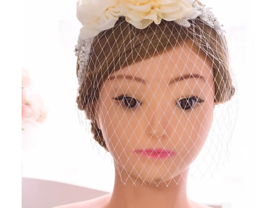 Bridal veil with flower headband worn on a mannequin head