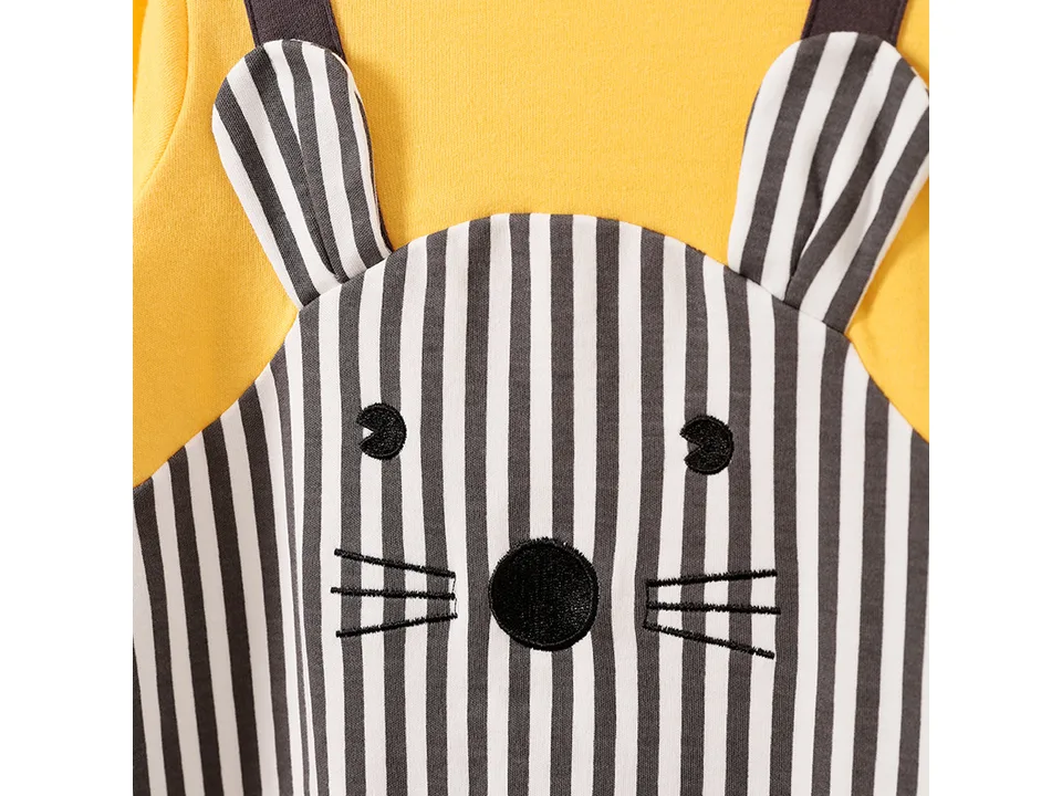 Close-up of the embroidered animal face on the striped section of the baby romper.