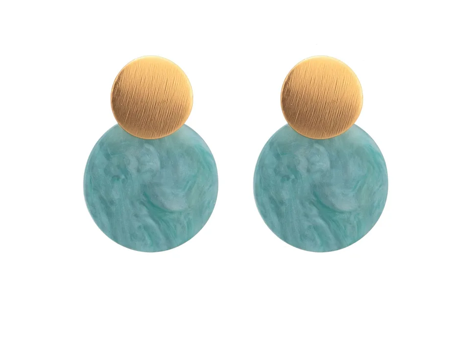 A pair of gold and teal circular drop earrings on a white background.