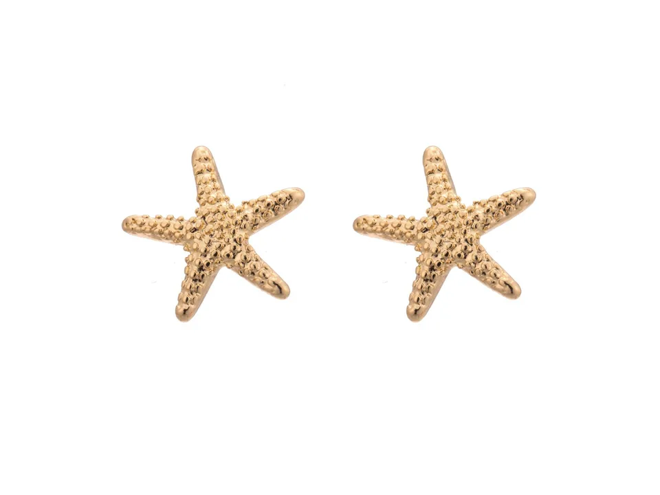 A pair of gold starfish-shaped stud earrings on a white background.
