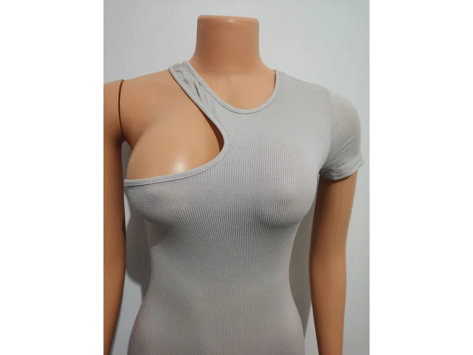 Close-up of the one-shoulder neckline detail on a grey jumpsuit