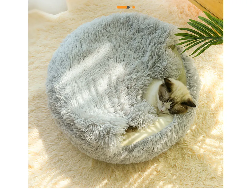 Cat sleeping inside the grey plush pet bed.