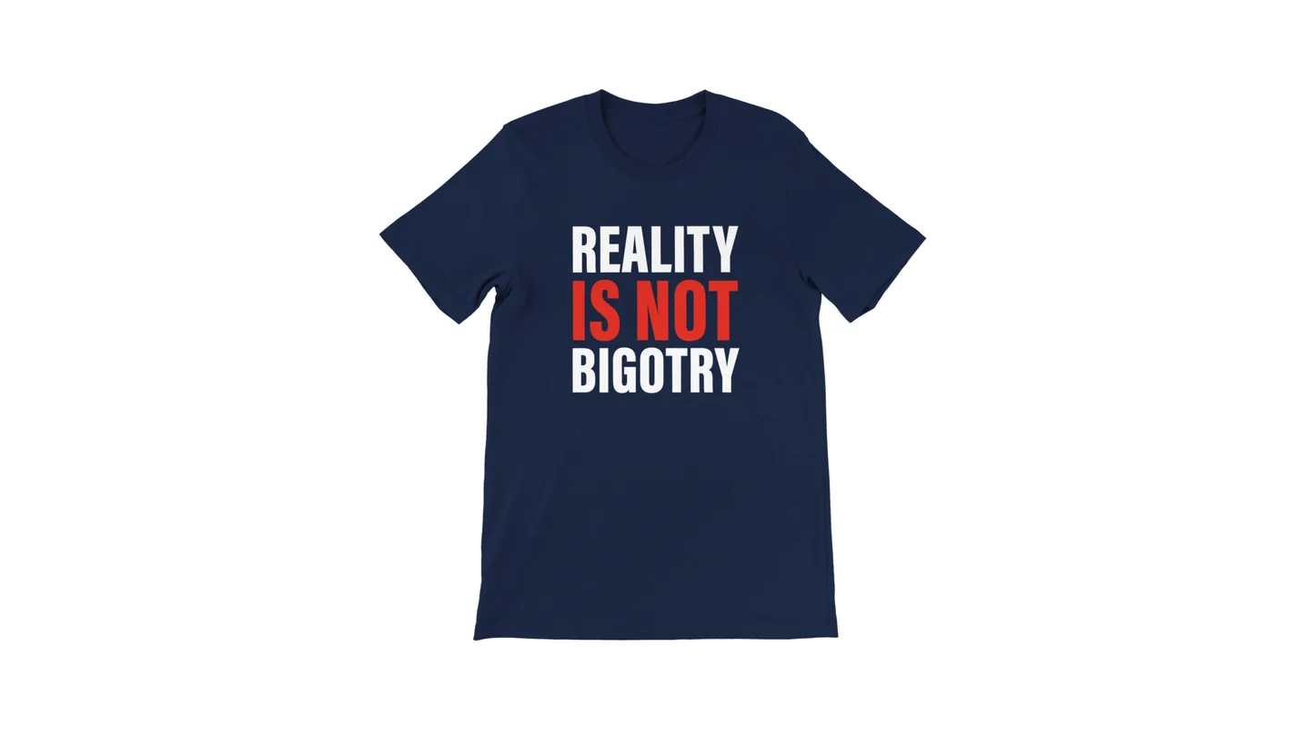 Navy blue t-shirt with the text 'REALITY IS NOT BIGOTRY' printed in white and red.