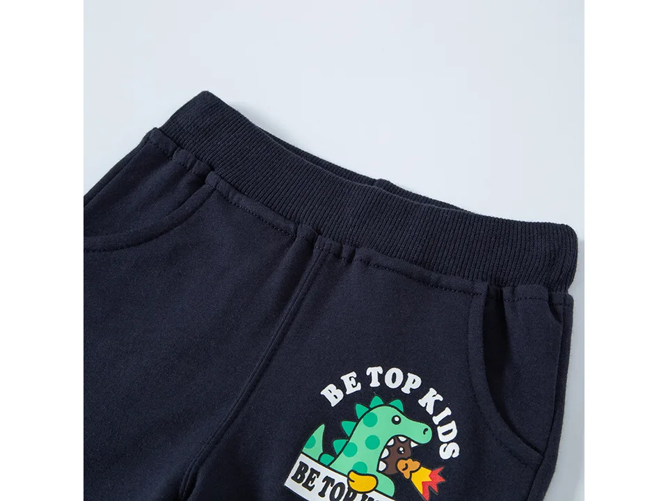 Close-up of the elastic waistband and pocket on the dark blue shorts.