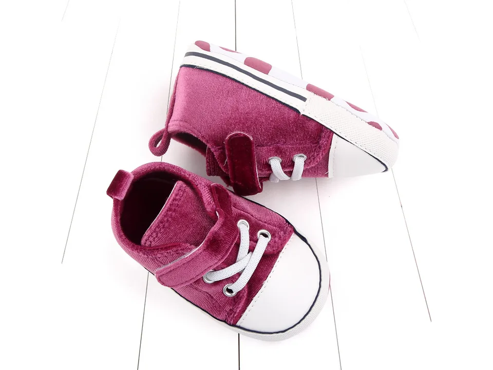 A pair of maroon toddler sneakers shown from the side and top.