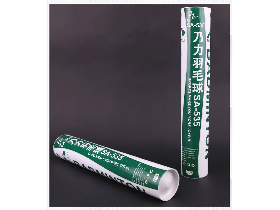 Two tubes of badminton shuttlecocks standing on a dark surface.