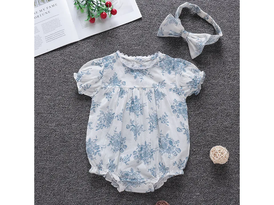 Front view of the floral baby romper and matching headband.