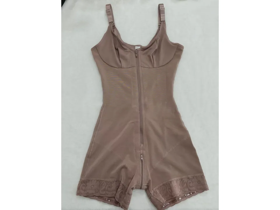 A beige full-body shapewear bodysuit laid flat.