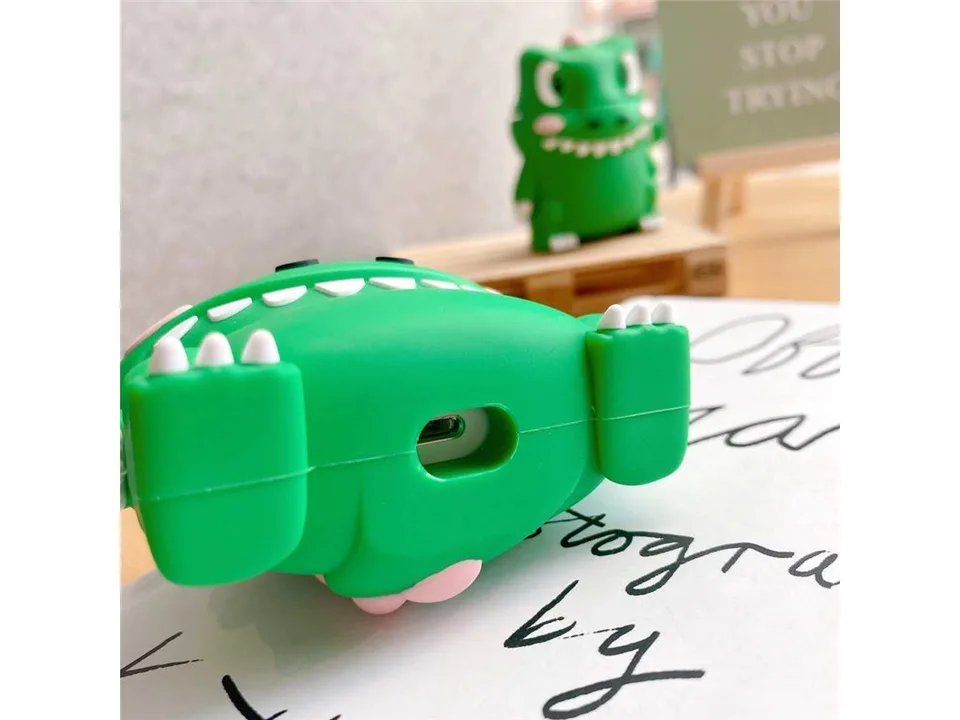 Bottom view of the green dinosaur silicone case showing the charging port cutout.
