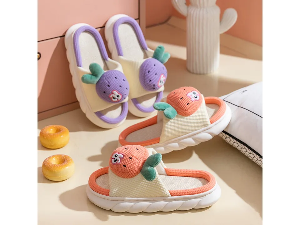 Two pairs of cute fruit-themed slippers, one orange and one purple, displayed together.