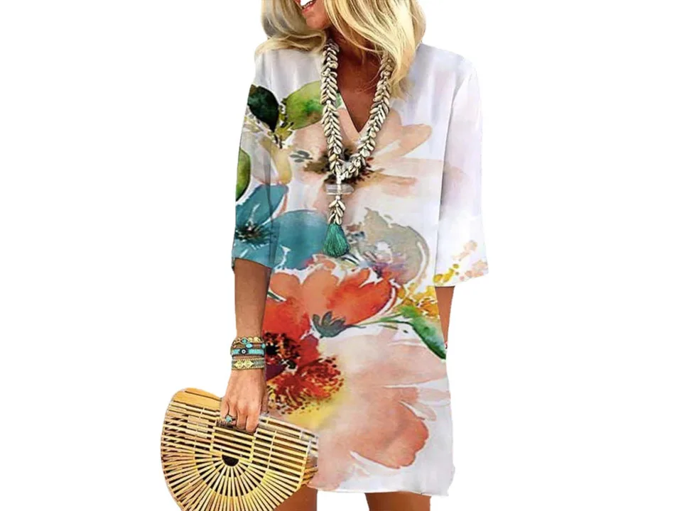 A woman wearing a floral print V-neck mini dress with half sleeves.