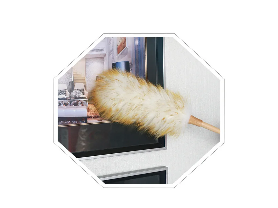 A wool duster cleaning the top of a framed picture on a wall.