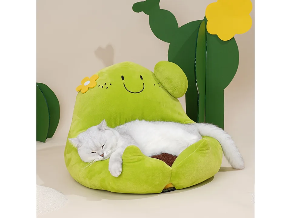A cat sleeping comfortably inside the cactus-shaped cat bed.