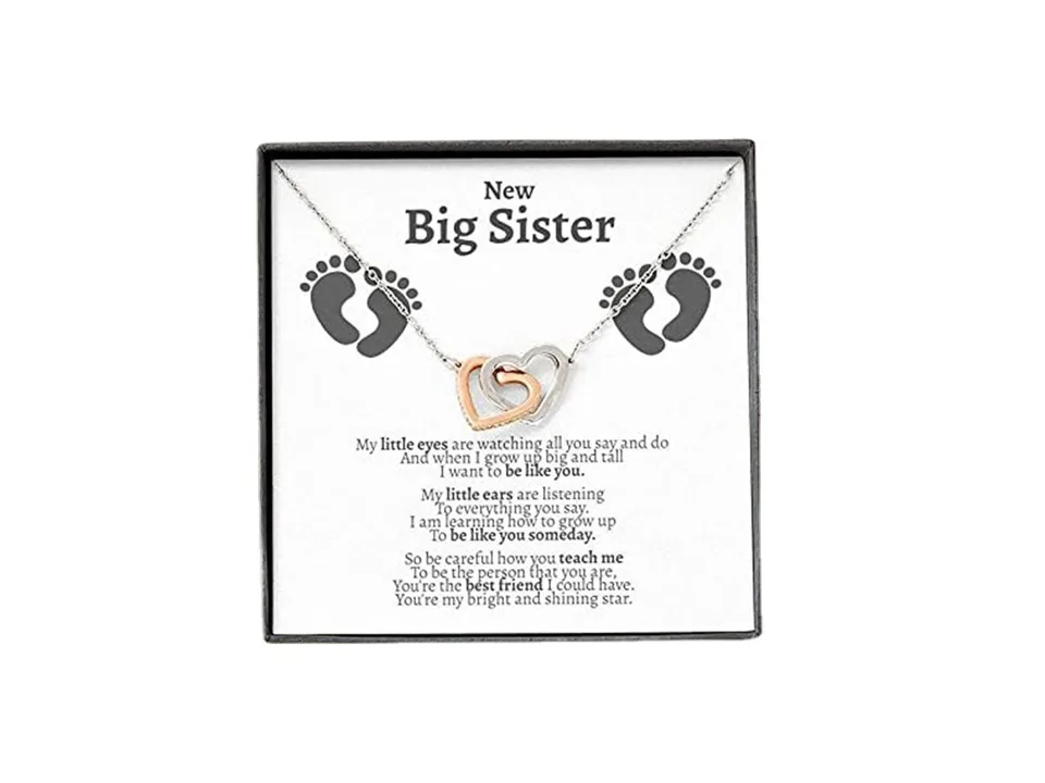 Interlocking double heart necklace in a gift box with a 'New Big Sister' message card.