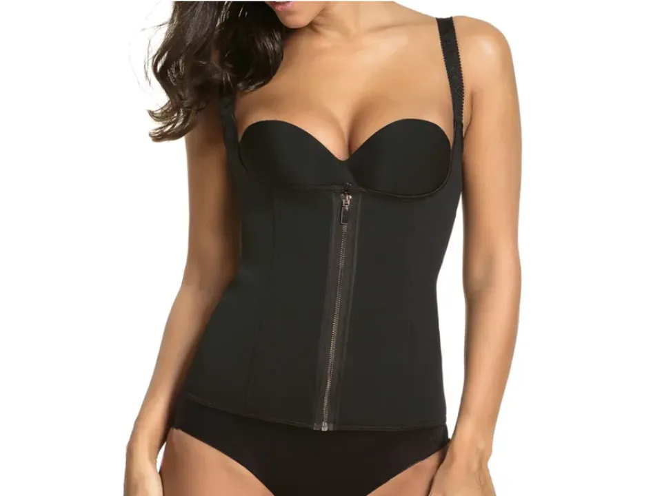 A woman wearing a black waist trainer corset with shoulder straps, fully zipped up.