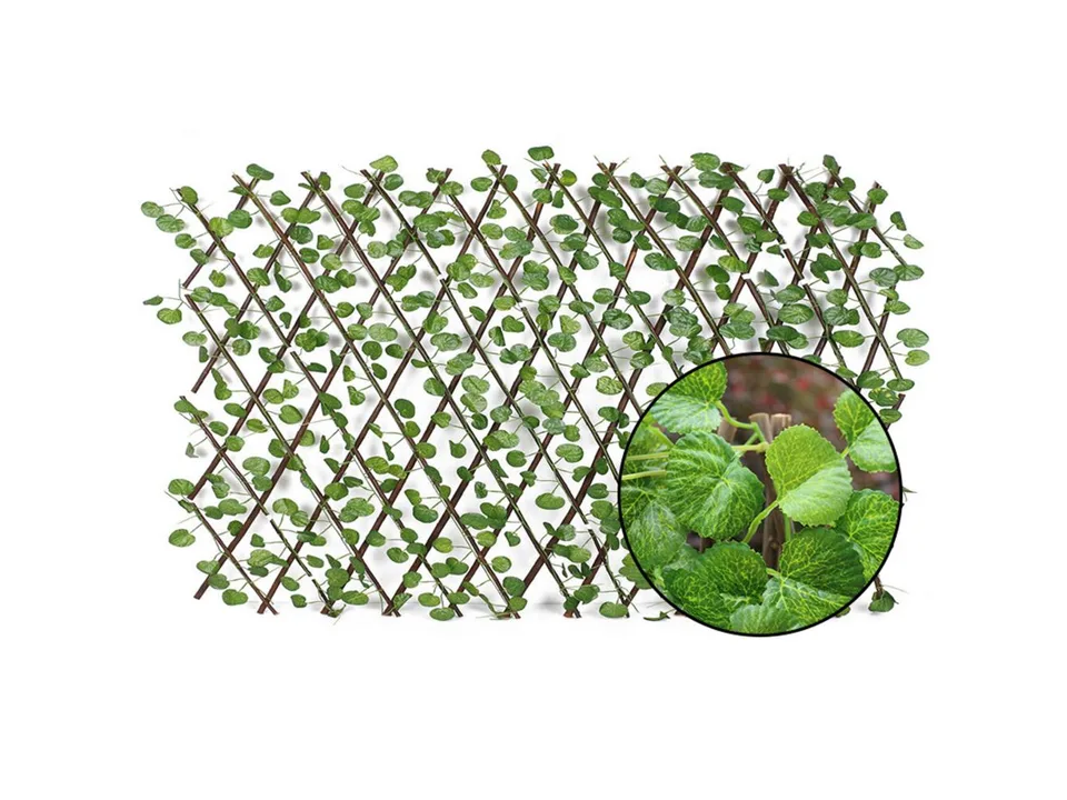 Close-up view of the artificial green leaves on the wooden lattice fence.