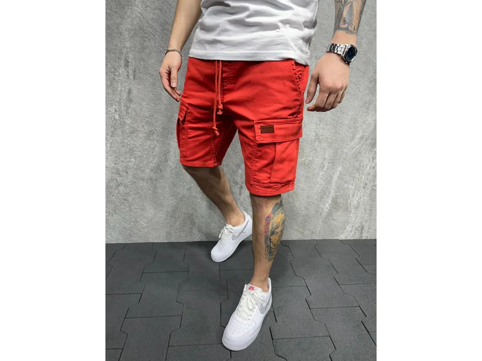 Man wearing red cargo shorts with side pockets and a drawstring waist.