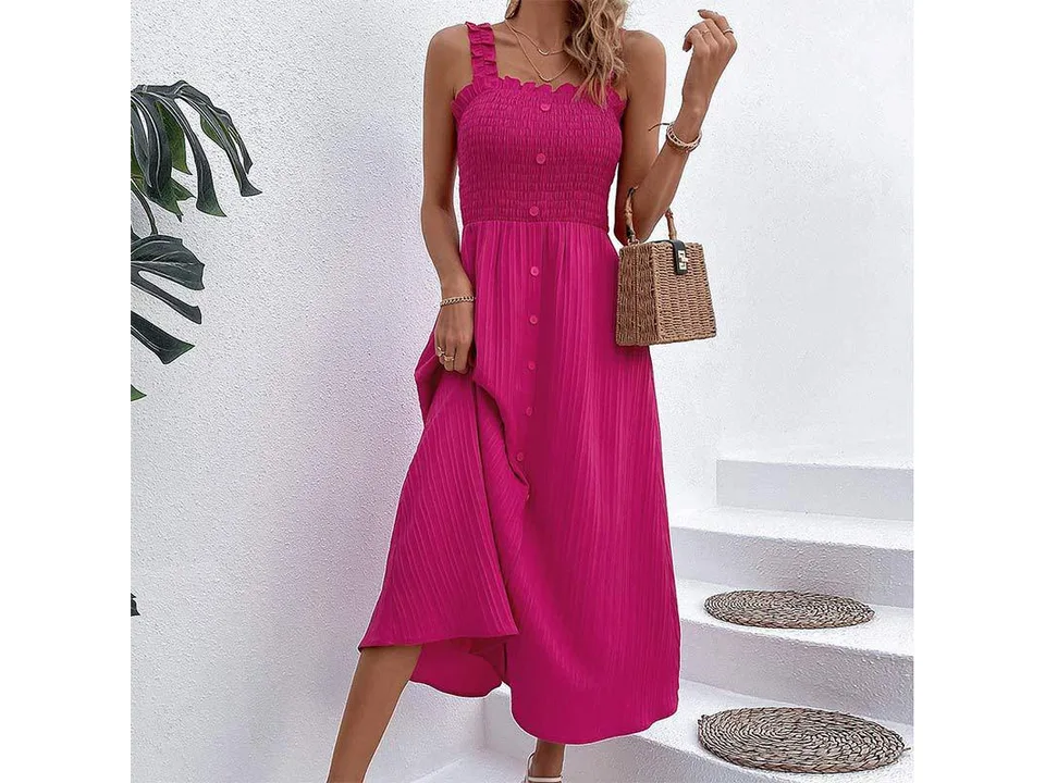 A model wearing a rose red midi suspender dress with a smocked bodice.