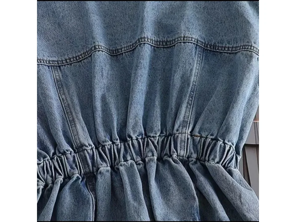 Close-up of the gathered waist detail on the denim jacket.