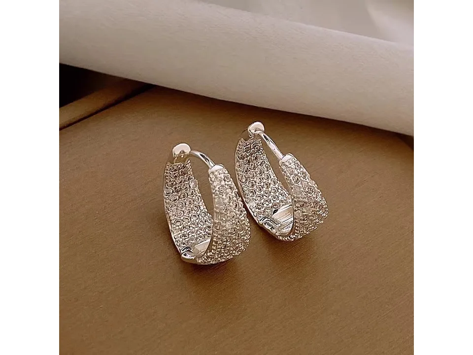 A pair of silver-tone geometric hoop earrings encrusted with cubic zirconia.