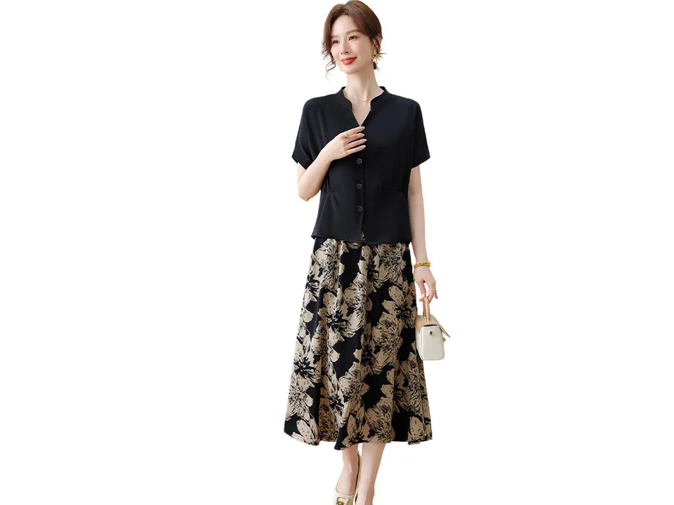 A model wearing a black shirt and floral skirt set on a white background.