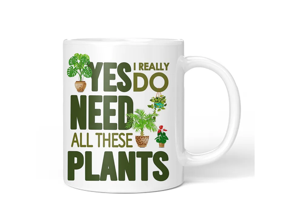 A single white ceramic mug with a plant-themed design and text.