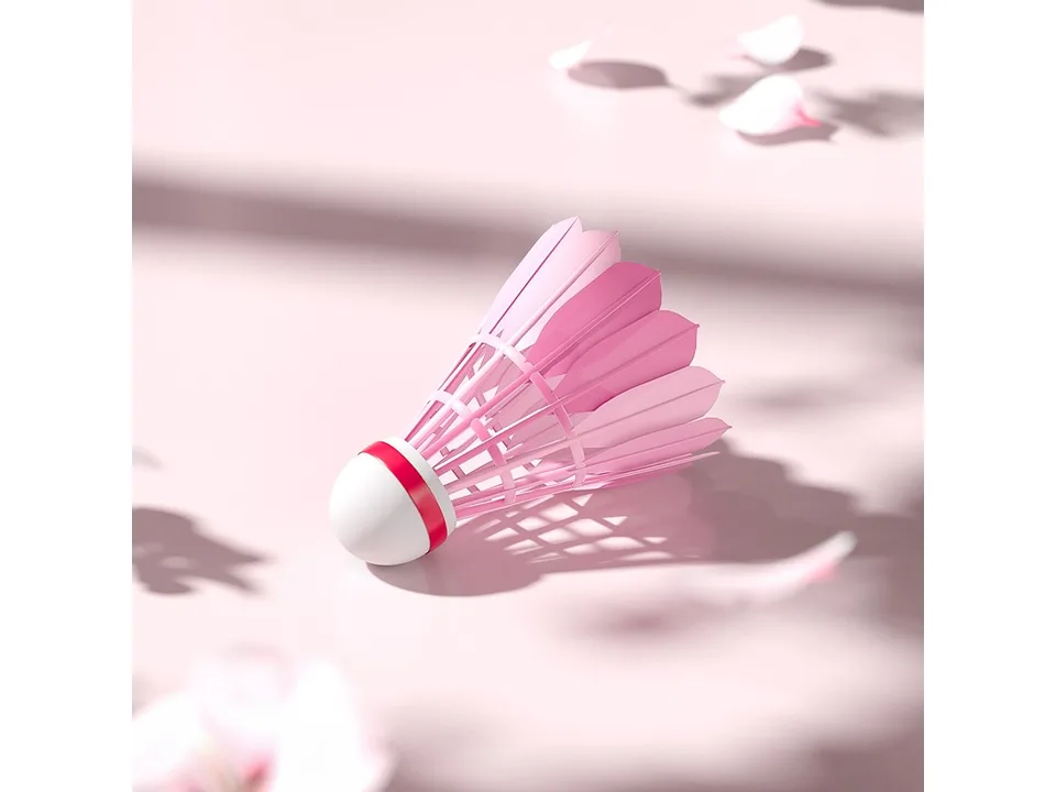 A single pink badminton shuttlecock with cherry blossom petal design.