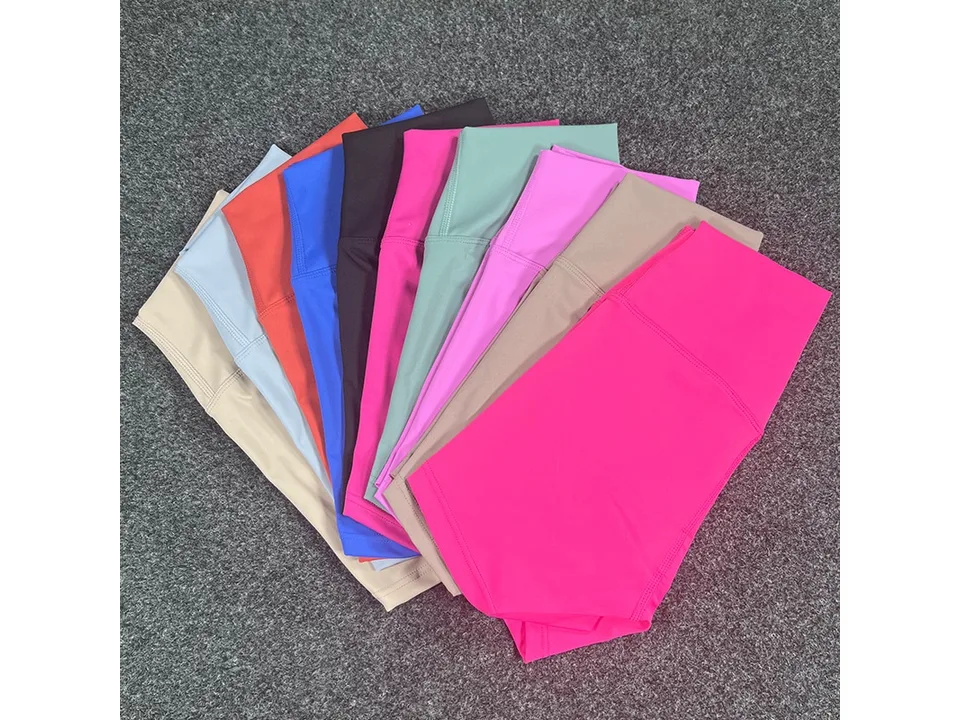 A fan of high-waisted yoga shorts in various colors including black, blue, pink, and green.