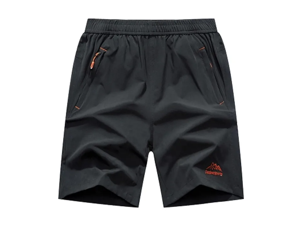 Black athletic gym shorts with orange zipper details and logo.