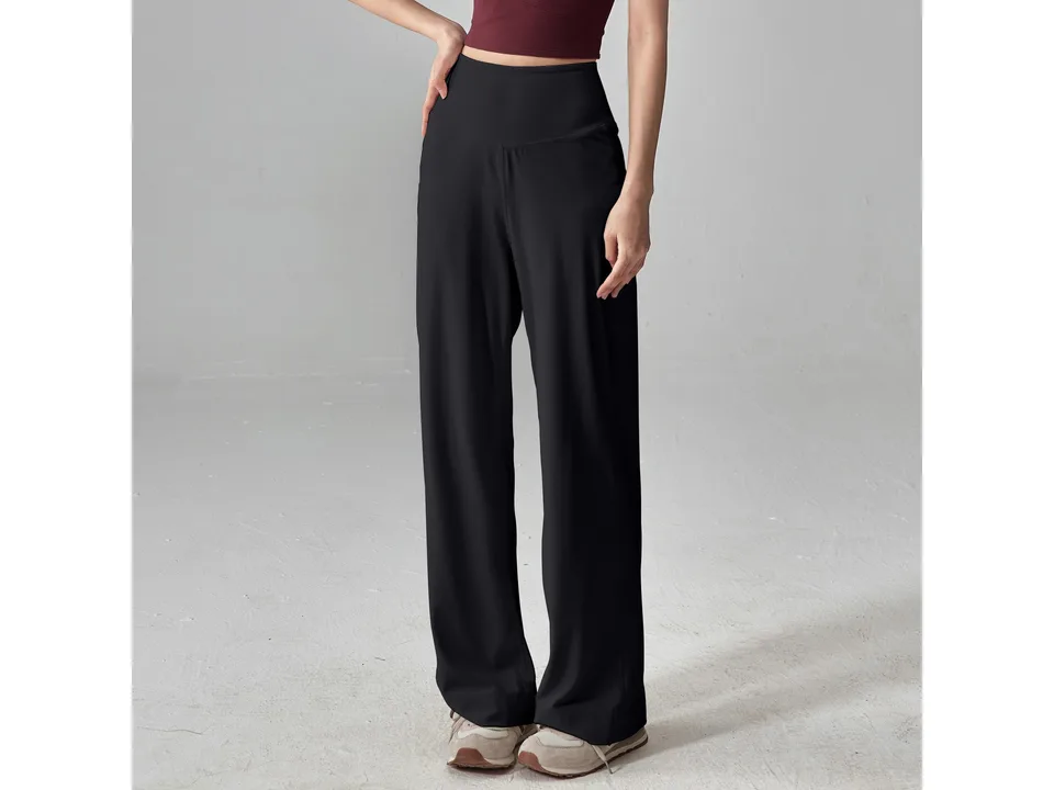 A model wearing black loose-fitting straight-leg yoga pants.