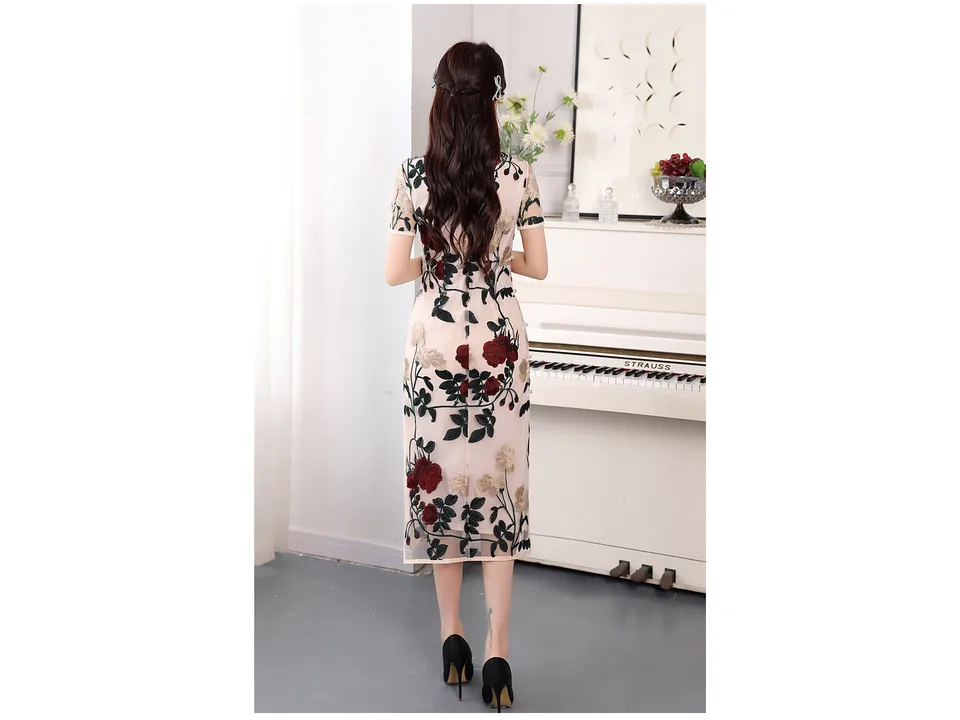 Back view of a woman wearing a floral embroidered cheongsam midi dress.