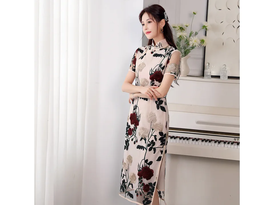 Side view of a woman wearing a floral embroidered cheongsam midi dress.