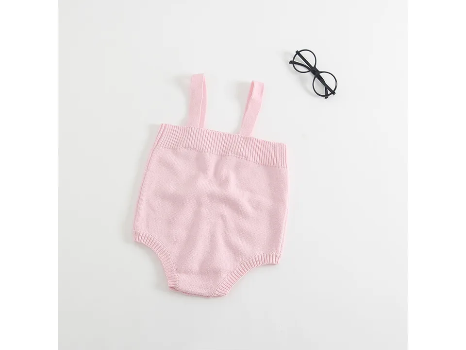 Back view of a pink knitted baby romper.